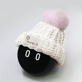 White hat with pink furball.
